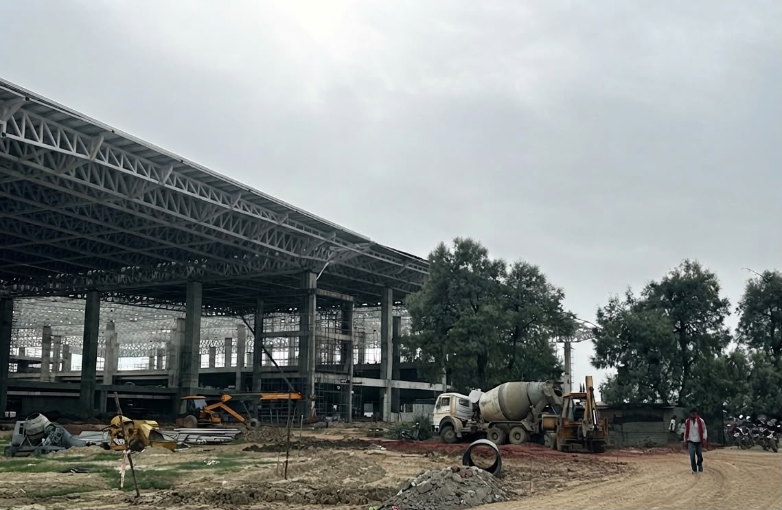 Agra Airport construction site 2026 - active construction with mixer trucks and machinery